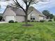 Beautifully landscaped single-Gathering home featuring manicured lawn and a side patio at 1604 Stonewall Dr, Greenfield, IN 46140