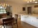 Bright eat-in kitchen features a breakfast bar, wood floors, and a view into the adjacent living room at 1604 Stonewall Dr, Greenfield, IN 46140