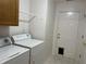 Laundry room with white washer and dryer, and a back door at 1604 Stonewall Dr, Greenfield, IN 46140