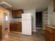 Open kitchen with ample counter space, white refrigerator, and wood cabinets offering storage solutions at 1605 S Whittier Pl, Indianapolis, IN 46203