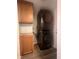 Convenient laundry area features modern stacked washer and dryer plus ample wood cabinet storage at 1605 S Whittier Pl, Indianapolis, IN 46203