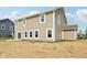 Backyard view of siding and windows with sliding glass door and patio at 1614 N Clearwater Dr, Greenfield, IN 46140