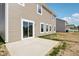Backyard view of siding and windows with sliding glass door and patio at 1614 N Clearwater Dr, Greenfield, IN 46140