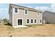Backyard view of siding and windows with sliding glass door and patio at 1614 N Clearwater Dr, Greenfield, IN 46140