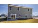 Exterior view of gray siding and a brick foundation, showing a sliding glass door to the backyard at 1614 N Clearwater Dr, Greenfield, IN 46140