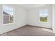 Bright bedroom featuring plush carpeting and view from double-hung windows at 1614 N Clearwater Dr, Greenfield, IN 46140