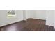 Bright bedroom with a large window, neutral walls, and light hardwood flooring at 1614 N Clearwater Dr, Greenfield, IN 46140