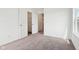 Carpeted bedroom with closet with open doors, white walls, and natural lighting at 1614 N Clearwater Dr, Greenfield, IN 46140