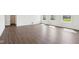 Bright, empty room featuring three windows, clean white walls, and hardwood floors at 1614 N Clearwater Dr, Greenfield, IN 46140
