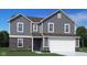 Charming two-story home featuring gray siding, brick accents, and a two-car garage at 1614 N Clearwater Dr, Greenfield, IN 46140