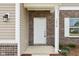 Front door entry with brick facade and beige vinyl siding at 1614 N Clearwater Dr, Greenfield, IN 46140