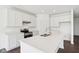 Modern kitchen features white cabinets, stainless steel appliances, and a large island with quartz countertops at 1614 N Clearwater Dr, Greenfield, IN 46140