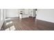 Open-concept living space featuring new hardwood floors, bright white walls, and a kitchen island at 1614 N Clearwater Dr, Greenfield, IN 46140