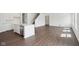Open living space showing modern kitchen with stainless steel appliances, white island, and hardwood floors at 1614 N Clearwater Dr, Greenfield, IN 46140