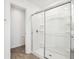 Bright bathroom showcasing a glass enclosed shower with a chrome sliding door and white wall tile at 1614 N Clearwater Dr, Greenfield, IN 46140