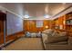 Finished basement featuring a projector screen, sofa, and wood paneling at 1709 E Loretta Dr, Indianapolis, IN 46227