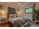 Cozy bedroom featuring a ceiling fan, hardwood floors, and large windows at 1709 E Loretta Dr, Indianapolis, IN 46227