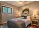 Cozy bedroom featuring a ceiling fan, hardwood floors, and natural light at 1709 E Loretta Dr, Indianapolis, IN 46227