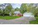 Charming exterior view of home featuring a detached garage, and well-maintained lawn at 1709 E Loretta Dr, Indianapolis, IN 46227