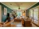 Comfortable living room features a large sectional, wood flooring, stylish decor, and backyard views at 1709 E Loretta Dr, Indianapolis, IN 46227