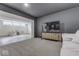 Finished basement featuring a comfortable white sectional sofa, large TV, and bonus room with a wet bar at 17346 Newton Main St, Westfield, IN 46074