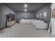 Finished basement featuring a comfortable white sectional sofa and large TV for entertaining at 17346 Newton Main St, Westfield, IN 46074