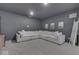 Finished basement featuring a comfortable white sectional sofa and large TV for entertaining at 17346 Newton Main St, Westfield, IN 46074