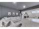 Finished basement featuring a comfortable white sectional sofa, large TV, bonus room and wet bar at 17346 Newton Main St, Westfield, IN 46074