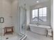 Bathroom featuring a glass shower and soaking tub with modern fixtures at 17346 Newton Main St, Westfield, IN 46074