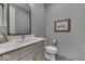 Bathroom with a modern vanity, decorative mirror and herringbone floors at 17346 Newton Main St, Westfield, IN 46074