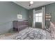 Neutrally decorated bedroom with crib, road-themed rug, and good natural light at 17346 Newton Main St, Westfield, IN 46074