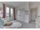 A view of a bedroom with a sitting area, French doors and neutral decor at 17346 Newton Main St, Westfield, IN 46074