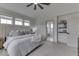 Bedroom showcasing neutral carpet, a ceiling fan, and an ensuite bathroom at 17346 Newton Main St, Westfield, IN 46074
