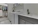 Convenient laundry room featuring modern washer, dryer, sink and gray cabinetry at 17346 Newton Main St, Westfield, IN 46074