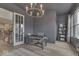 Well-lit home office featuring a stylish desk, a modern chandelier, and ample natural light at 17346 Newton Main St, Westfield, IN 46074