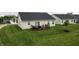 View of the backyard with a wooden deck, sliding glass doors, and well-maintained lawn at 17949 Scout Ln, Westfield, IN 46074