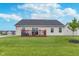 Spacious backyard featuring a wooden deck, sliding glass doors, and lush green lawn at 17949 Scout Ln, Westfield, IN 46074