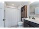 Bathroom featuring a shower-tub combo, modern vanity, dark cabinets and shelves at 17949 Scout Ln, Westfield, IN 46074