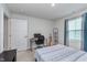 Neutrally colored bedroom with simple decor, a window with blinds, and a desk for studying at 17949 Scout Ln, Westfield, IN 46074