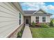 Inviting front entrance featuring a well-maintained walkway and garden bed with beautiful flowers and shrubbery at 17949 Scout Ln, Westfield, IN 46074