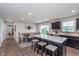 Bright, open kitchen featuring dark cabinets, an island with seating, and stainless steel appliances at 17949 Scout Ln, Westfield, IN 46074