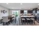 Well-lit kitchen with a center island, dining area, and sliding glass doors to the deck at 17949 Scout Ln, Westfield, IN 46074