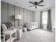 Cozy Bedroom with gray accents, a white crib, glider and soft carpeting at 2016 Central Ave, Indianapolis, IN 46202