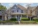 Charming two-story home with a covered front porch, beautiful landscaping, and traditional architectural details at 2016 Central Ave, Indianapolis, IN 46202