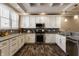 Modern kitchen boasting white cabinets, granite countertops, and stainless steel appliances at 2016 Central Ave, Indianapolis, IN 46202