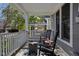 Inviting covered porch with rocking chairs and a stylish rug, perfect for relaxing and enjoying the outdoors at 2016 Central Ave, Indianapolis, IN 46202
