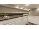 Basement wet bar with a stainless steel sink, cabinets, and a granite countertop at 2016 Central Ave, Indianapolis, IN 46202