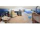 The attic is a versatile and cozy space with a soft neutral carpet, blue walls, a comfortable chair, and baby furniture at 2025 E Broadway St, Fortville, IN 46040