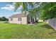 The spacious backyard with an outdoor dining area provides a peaceful retreat for relaxing and entertaining at 2025 E Broadway St, Fortville, IN 46040