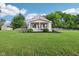 Inviting home with a well-kept lawn, quaint front porch, white picket fence, and lush landscaping at 2025 E Broadway St, Fortville, IN 46040